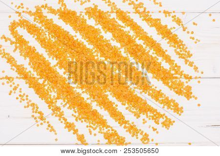 Lot Of Whole Raw Red Lentils Flatlay On Grey Wood