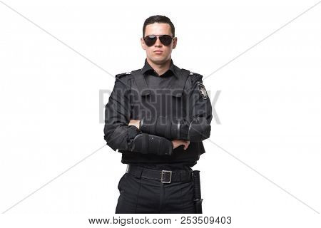 Seriuse cop in sunglasses, uniform with body armor