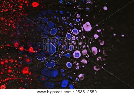 Abstract texture. Modern artwork background. Mixed black red and blue pianting. Fluid Art. Unusual trendy background for poster, card, invitation. Contemporary art.