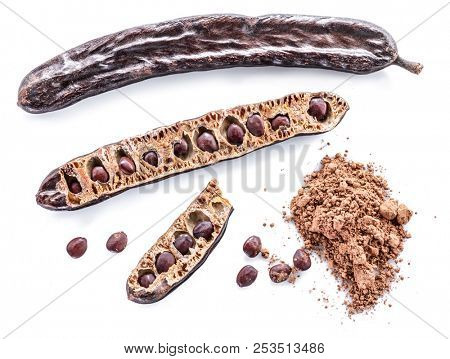 Carob pods and carob powder on the white background.