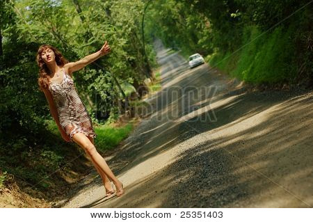 Pretty girl hitching hiking.