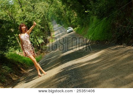 Pretty girl hitching hiking.
