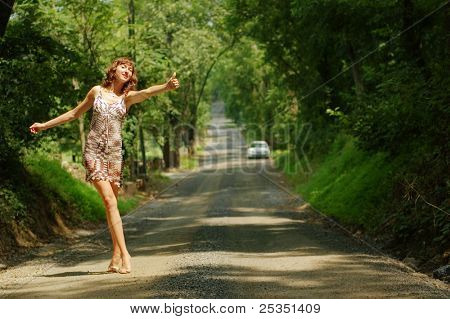 Pretty girl hitching hiking.