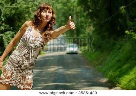 Pretty girl hitching hiking.