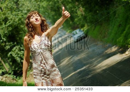 Pretty girl hitching hiking.