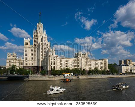 Moscow, Russia - May 12. 2018. Moskva - Ships Sail On River Past Skyscraper On Kotelnicheskaya Emban