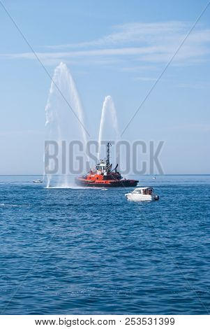 Two Jets Of Sea Water Sprayed By A Fire Engine Of A Firefighters Red Boat