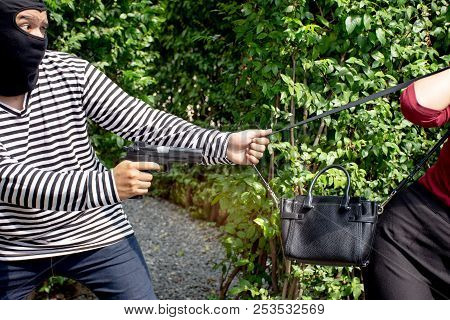 Robber Thief Criminal With Gun Standing Behind A Asian Women And To Come Nearest For Scramble The Va