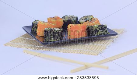 Different Types Of Maki Sushi On A Black Plate