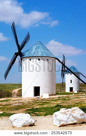 Famous Old Spanish Windmills Campo De Criptana Cariari And Lagarto Against Blue Cloudy Sky Outdoors.