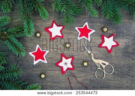 Christmas Party Preparation Background With Sewing Star Figures From Red Anf White Felt, Needle With
