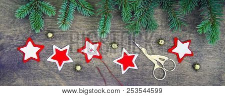 Christmas Party Preparation Background With Sewing Star Figures From Red Anf White Felt, Needle With