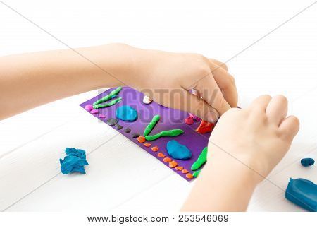 A Child Kneads Plasticine And Sculpts An Aquarium With Fish. Tutoring With Children