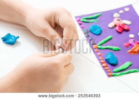 A Child Kneads Plasticine And Sculpts An Aquarium With Fish. Tutoring With Children