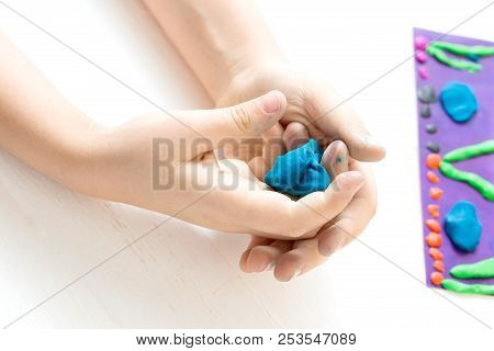 A Child Kneads Plasticine And Sculpts An Aquarium With Fish. Tutoring With Children