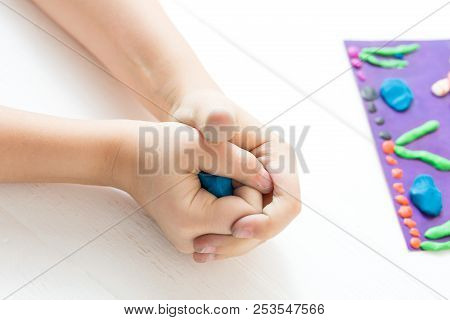 A Child Kneads Plasticine And Sculpts An Aquarium With Fish. Tutoring With Children