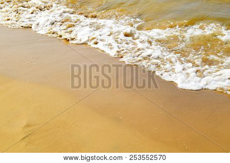 Wave With White Foam Of The Baltic Sea. Wet Sand Of The Coastal Beach. Сoastline