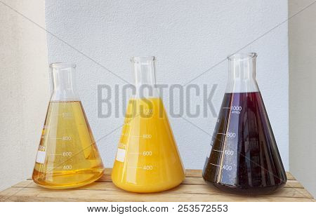 Glass Conical Erlenmeyer Flask Filled With Fruit Juices. Vitamin Concept.solution Of Vitamin In Labo