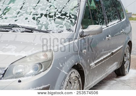 Car Wash With Foam In Car Wash Station. Carwash. Washing Machine At The Station. Car Washing Concept