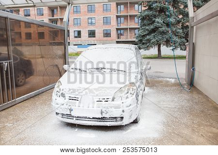 Car Wash With Foam In Car Wash Station. Carwash. Washing Machine At The Station. Car Washing Concept