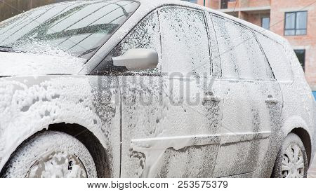 Car Wash With Foam In Car Wash Station. Carwash. Washing Machine At The Station. Car Washing Concept