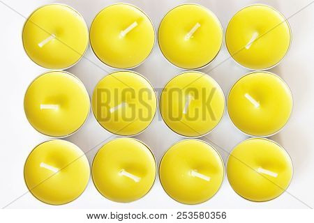 Set Of Yellow Unlit New Tea Candles, Top View.