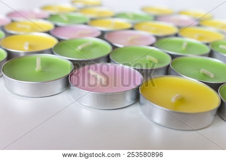 Decorative Colored Tea Candles Of Pink, Yellow And Green Colors.