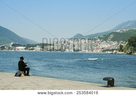 Herceg Novi, Montenegro - April 3, 2007: Fisherman Fishing On A Quay In Herceg Novi, Facing The Igal