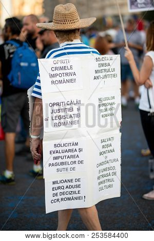 Romania, Bucharest - August 11, 2018: Protester Wearing Placard With Hate Speech Against Corrupted G
