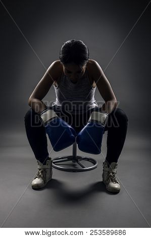 Black Female Wearing Boxing Gloves Looking Angry As A Boxer, Mma Fighter Or Self Defense Trainer Sit