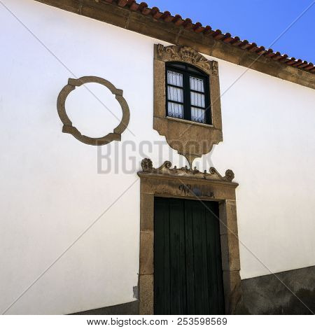 Castelo Melhor, Portugal - June 19, 2018:  View Of The Main Entrance Portal And Above Window Of A Ma