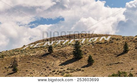 Huge Penticton Sign On The Ground Withcloudy Sky On The Background.