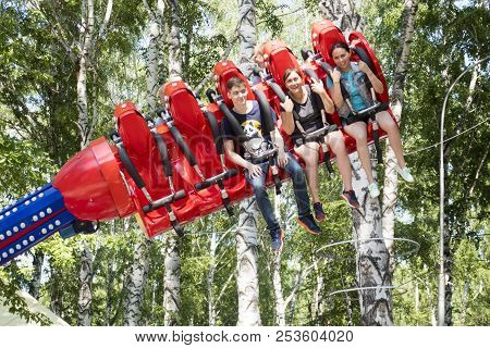 People Are Sitting On An Attraction In Gagarin Park, July 1, 2018, Russia, The City Of Sterlitamak