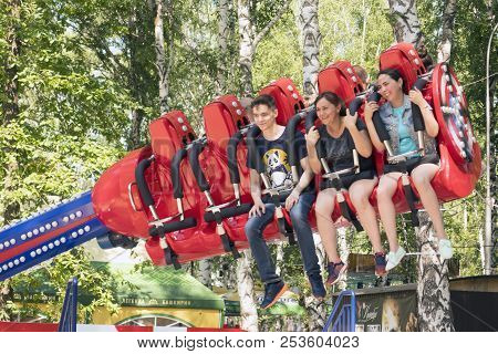 People Are Sitting On An Attraction In Gagarin Park, July 1, 2018, Russia, The City Of Sterlitamak