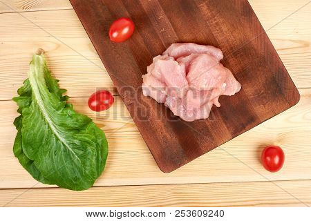 Raw Turkey Fillet Pieces On A Cutting Board Wooden Background