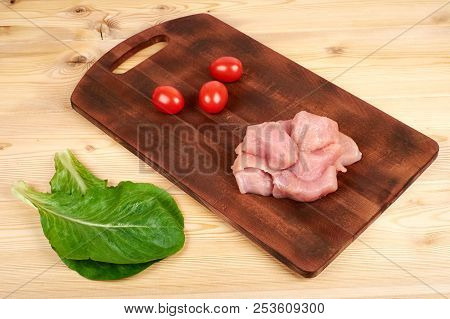 Raw Turkey Fillet Pieces On A Cutting Board Wooden Background