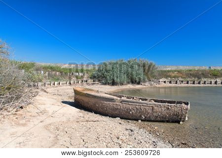Ile de RÃ© Salt lake with old wooden rowing boat in landscape