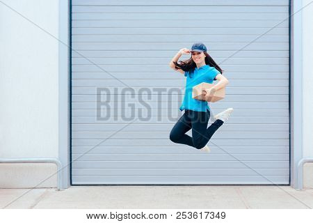 Female Delivery Worker Jumping In Front Of A Storage Warehouse