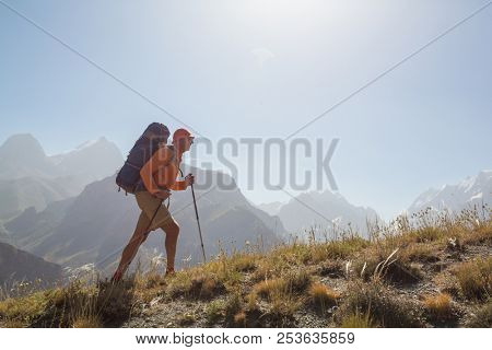 Wanderlust time. Man hiking in beautiful Fann mountains in Pamir, Tajikistan. Central Asia.