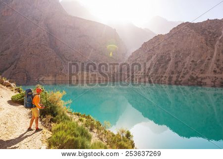 Wanderlust time. Man hiking in beautiful Fann mountains in Pamir, Tajikistan. Central Asia.
