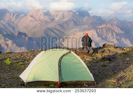 Wanderlust time. Man hiking in beautiful Fann mountains in Pamir, Tajikistan. Central Asia.