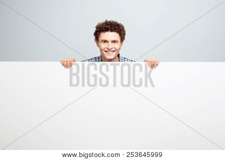 Portrait Of Beautiful Curlu Man Hold White Blank Board With Copy Space For Text