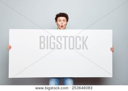 Portrait Of Curlu Hair Man Hold White Blank Board With Copy Space For Text Isolated On Light Gray Ba
