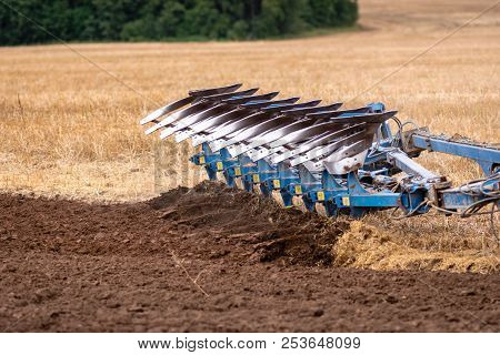 A Tractor With A Plow Treats The Soil.