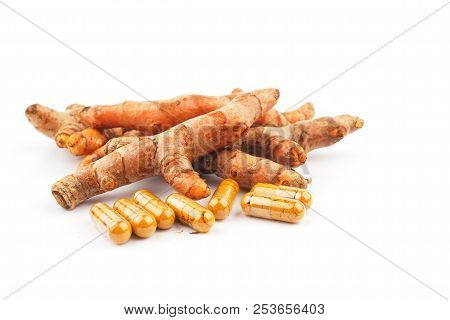 Fresh Turmeric And Turmeric Capsules On White Background. Herbal