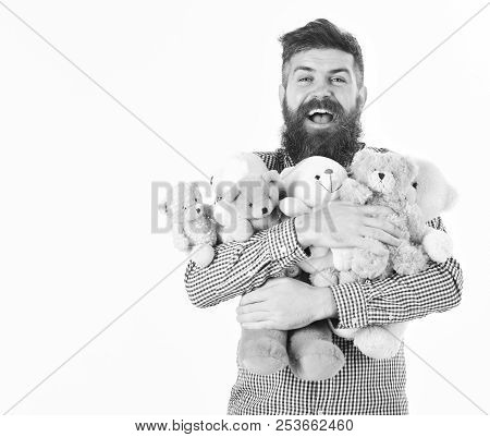 Macho With Beard Hugs Many Teddy Bears And Plush Toys. Gifts And Holidays Concept. Man With Happyfac