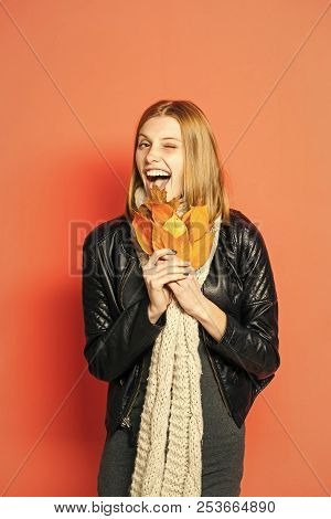 Happy Model With Stylish Hair In Scarf. Woman With Autumn Leaves In Leather Jacket. Beauty And Fashi