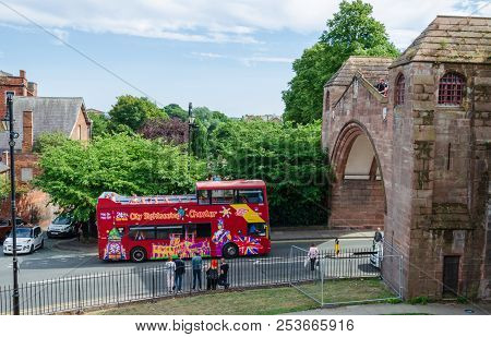 Chester, Uk: Aug 6, 2018: A Sightseeing Double Deck Bus Drives Under Newgate In The Historic City Of