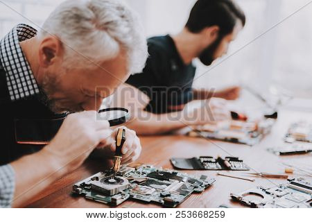Two Men Repairing Hardware Equipment From Pc. Repair Shop. Worker With Tools. Computer Hardware. You