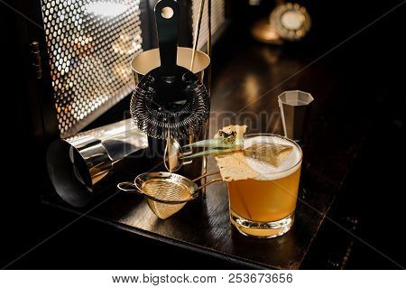 Top View Of Fresh And Sour Yellow Decorated Alcoholic Summer Cocktail And Utensils Arranged On The B